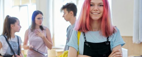 Portrait of smiling teenage girl in class on break Portrait of smiling teenage girl in class on break